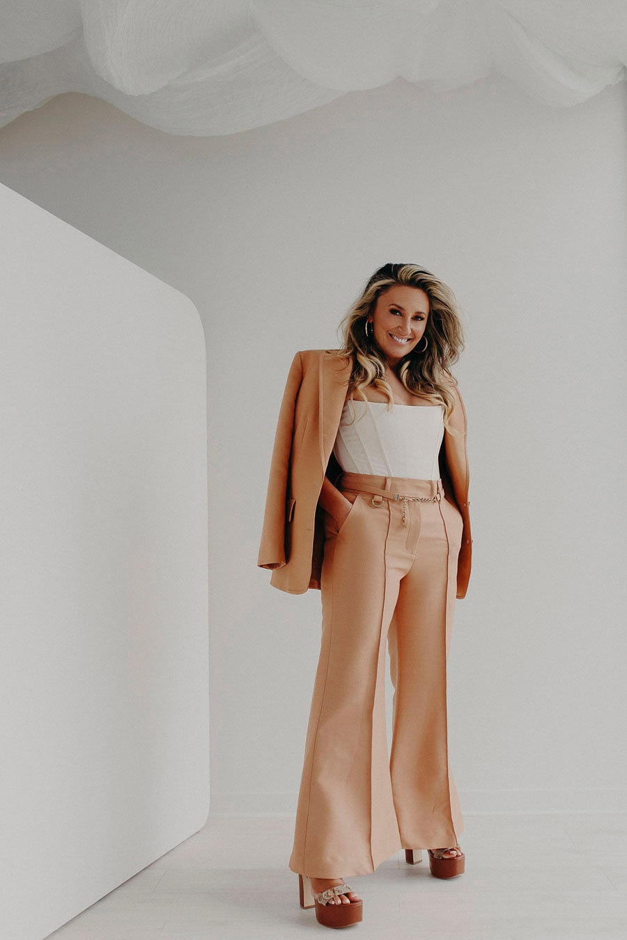 Sarah Adele, The Somatic CEO, standing and smiling at her audience